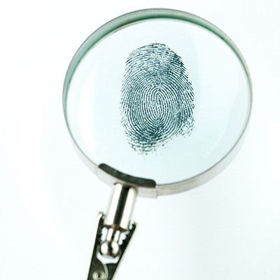 Magnifying glass focused on a fingerprint